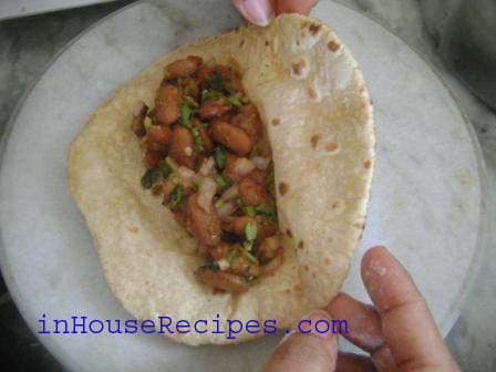 Chapati is ready. Keep it in a plate and add the Rajma mixture at the center of chapati.